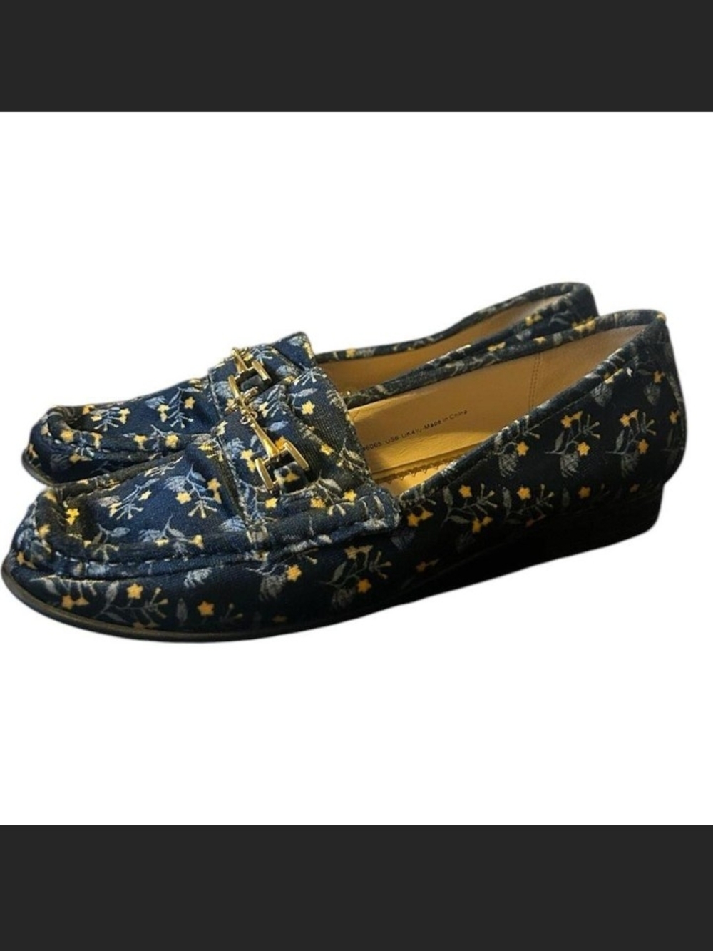 Cabi navy slip-on loafers with a small floral print. Gold-tone buckle accent